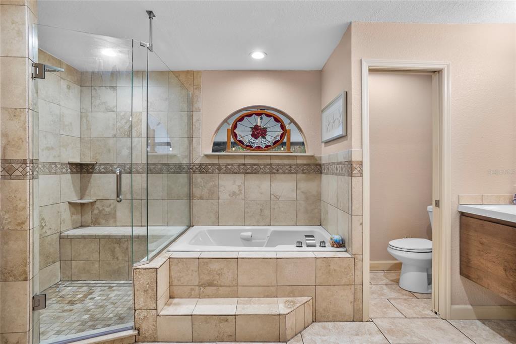 14612 Bray Road Orlando, FL 32832 - Photo 18 of 33 a bathroom with a bathtub a toilet and a shower