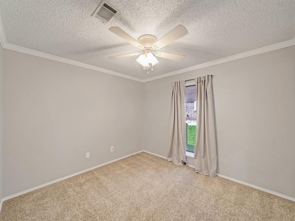 121 Northeast Brushy Mound Road Burleson, TX 76028 - Photo 22 of 35 an empty room with a window and a ceiling fan