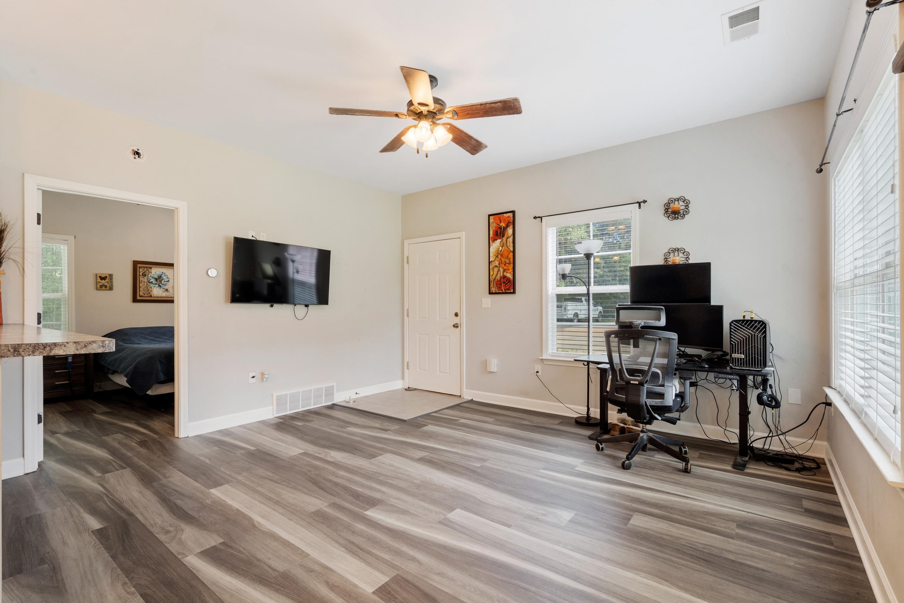 7757 Brunswick Road Millington, TN 38053 - Photo 25 of 40 Living area featuring wood-finish flooring, a ceiling fan, and light gray wall paint