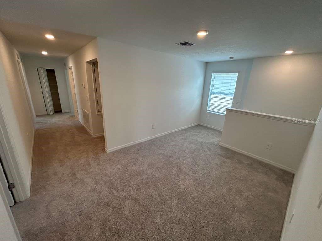 1140 Hour Glass Road Lakeland, FL 33801 - Photo 12 of 24 an empty room with windows and refrigerator