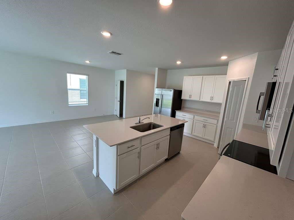 1140 Hour Glass Road Lakeland, FL 33801 - Photo 5 of 24 a kitchen with a refrigerator a sink and a refrigerator