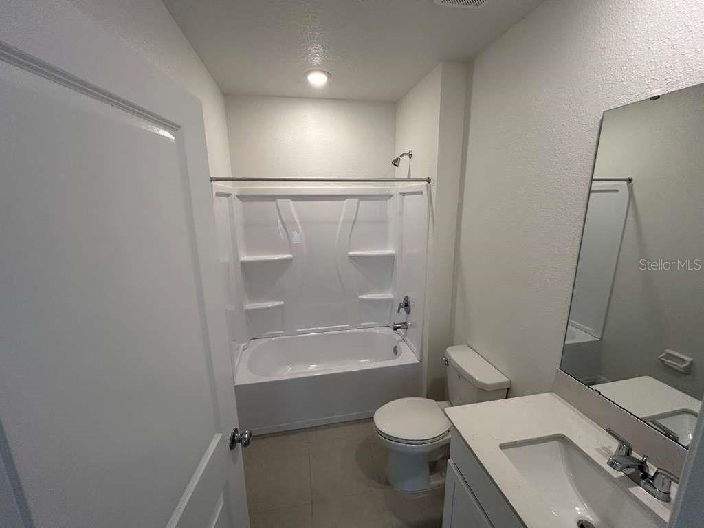 1140 Hour Glass Road Lakeland, FL 33801 - Photo 8 of 24 a bathroom with a sink a toilet and shower