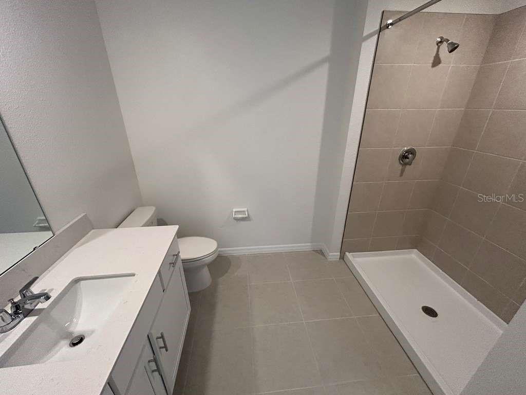 1140 Hour Glass Road Lakeland, FL 33801 - Photo 10 of 24 a bathroom with a sink a toilet and shower