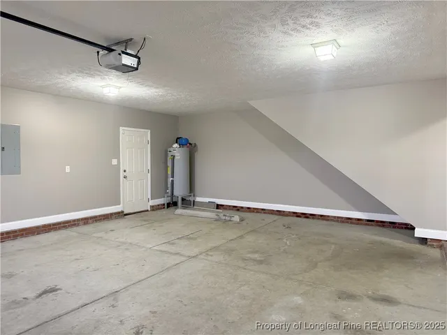 an empty room with a ceiling fan and window