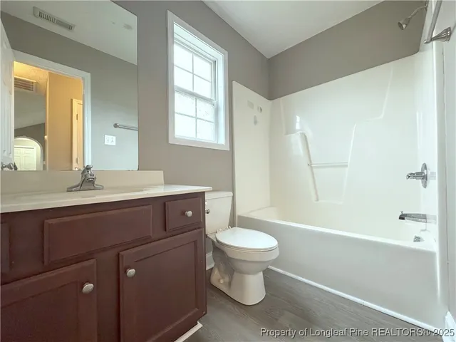 a bathroom with a sink toilet a mirror and shower