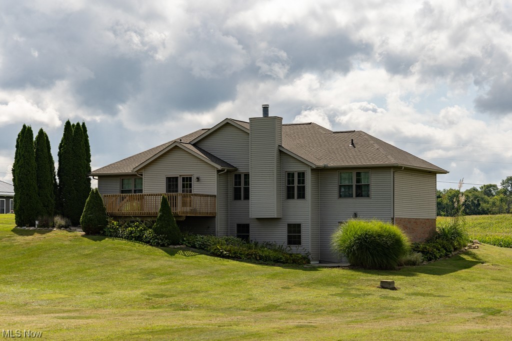 8383 Ickes Road Wooster, OH 44691 - Photo 5 of 32 Rear view of house with a lawn and a wooden deck