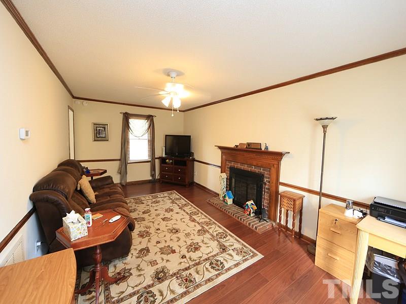 7301 Ewing Place Raleigh, NC 27616 - Photo 2 of 12 a living room with furniture and a fireplace