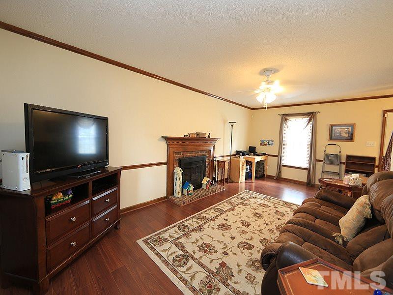 7301 Ewing Place Raleigh, NC 27616 - Photo 3 of 12 a living room with furniture and a flat screen tv