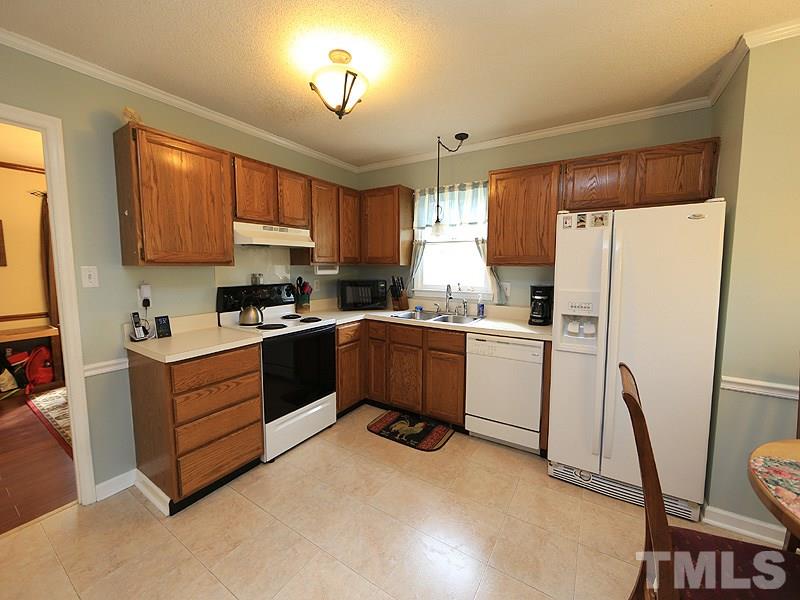 7301 Ewing Place Raleigh, NC 27616 - Photo 5 of 12 a kitchen with a refrigerator sink and cabinets