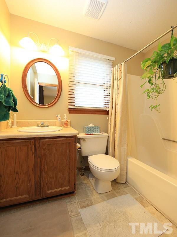 7301 Ewing Place Raleigh, NC 27616 - Photo 8 of 12 a bathroom with a toilet a sink and a mirror