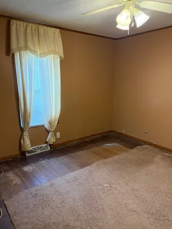 a view of a room with window and a chandelier