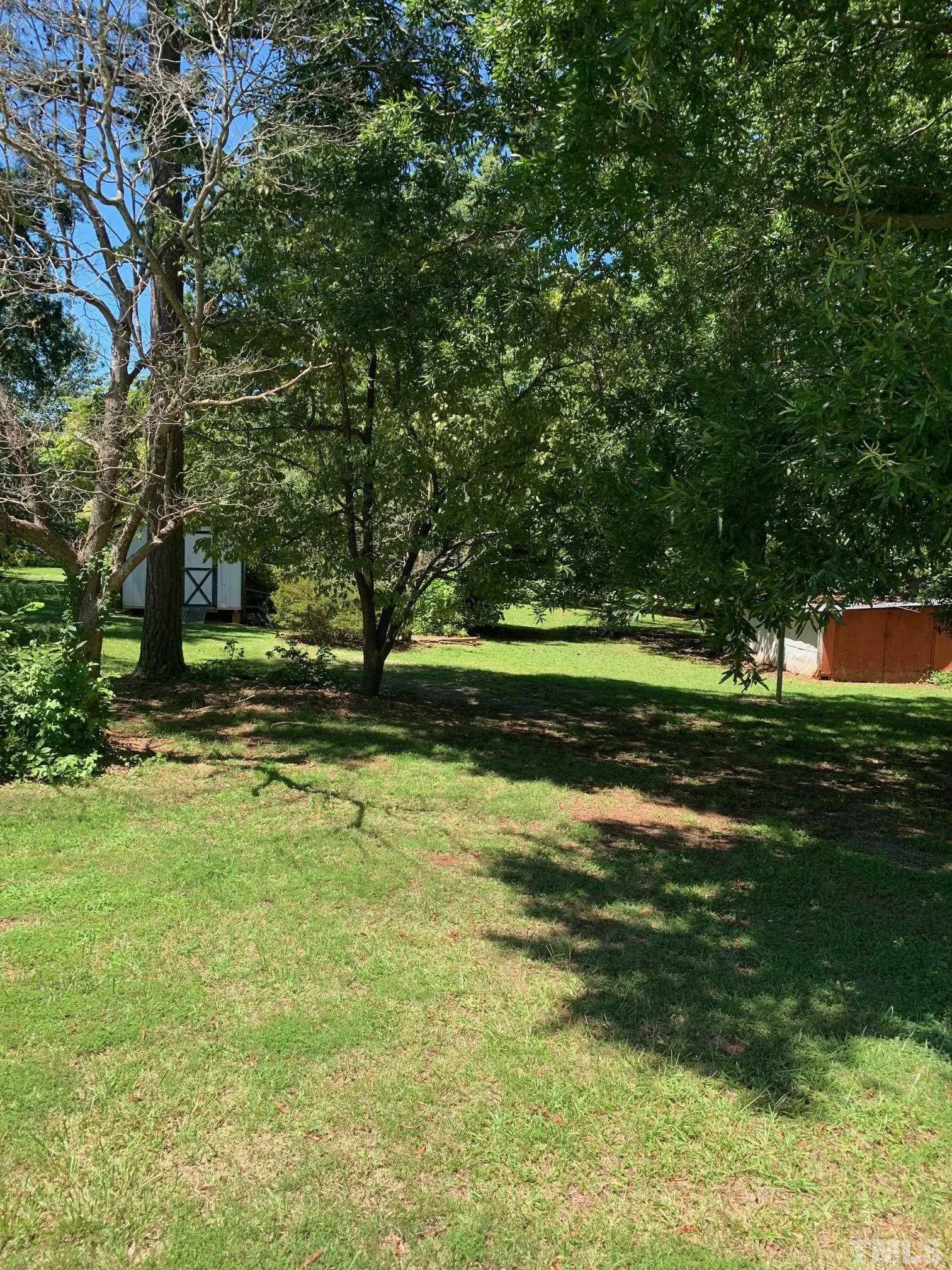 0 Stone Roxboro, NC 27573 - Photo 3 of 5 a backyard of a house with a yard and outdoor seating