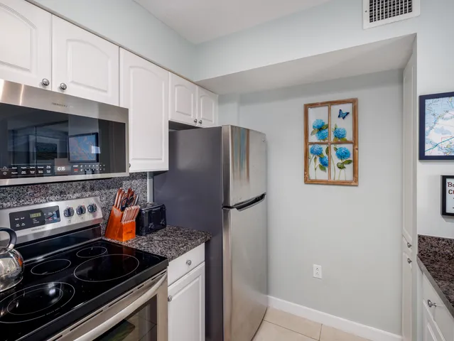 a kitchen with stainless steel appliances granite countertop a stove and a refrigerator