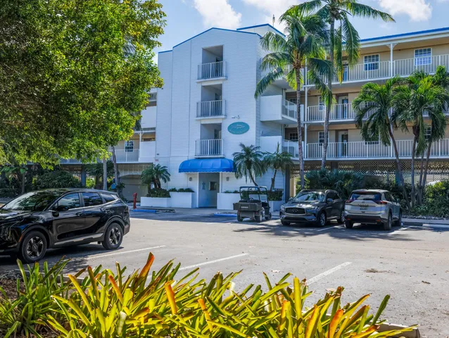 a view of a patio with table and chairs potted plants with wooden fence