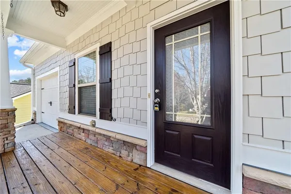 a view of a hallway with wooden floor and a fireplace
