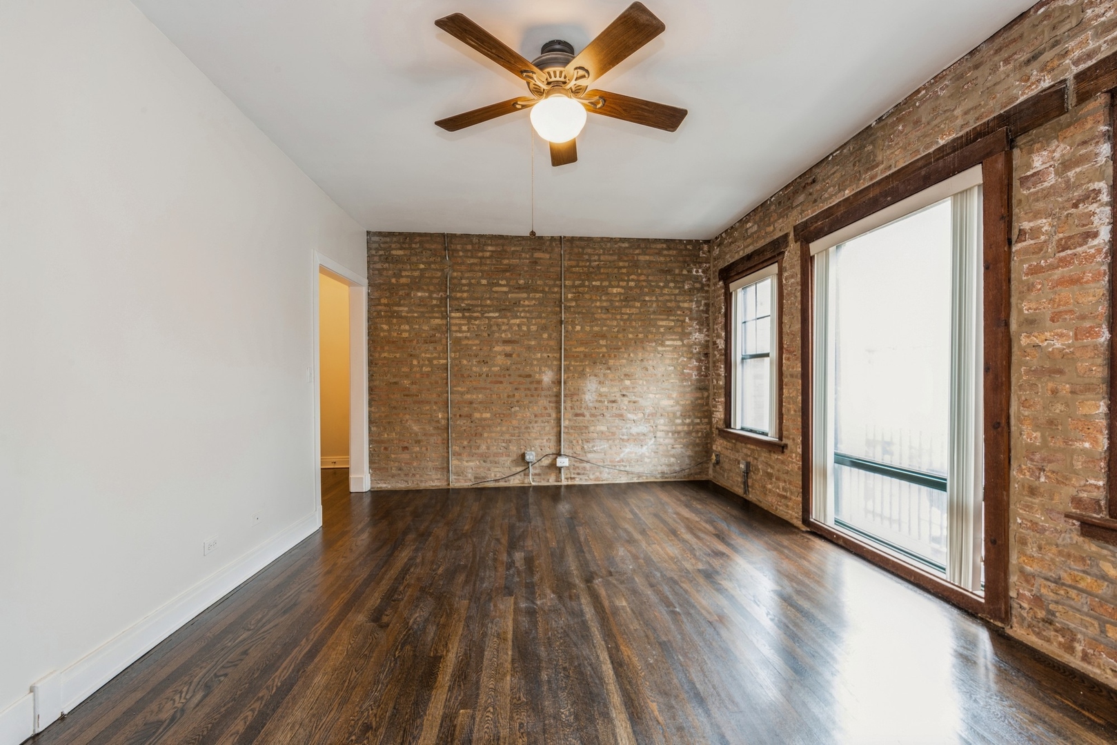 7023 North Sheridan Road, Unit 2E Chicago, IL 60626 - Photo 2 of 10 wooden floor in an empty room with a window