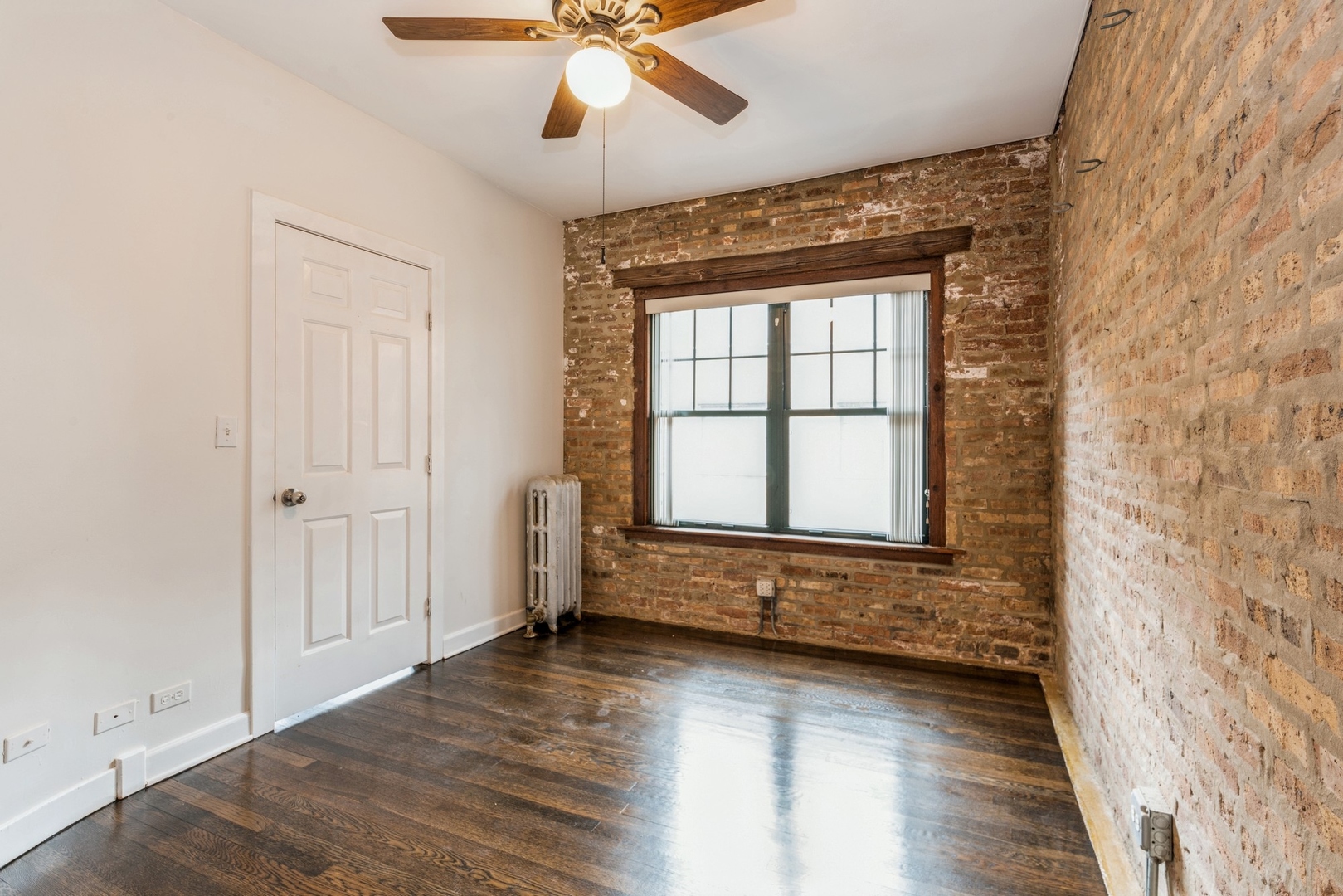 7023 North Sheridan Road, Unit 2E Chicago, IL 60626 - Photo 7 of 10 a view of an empty room with a window and wooden floor