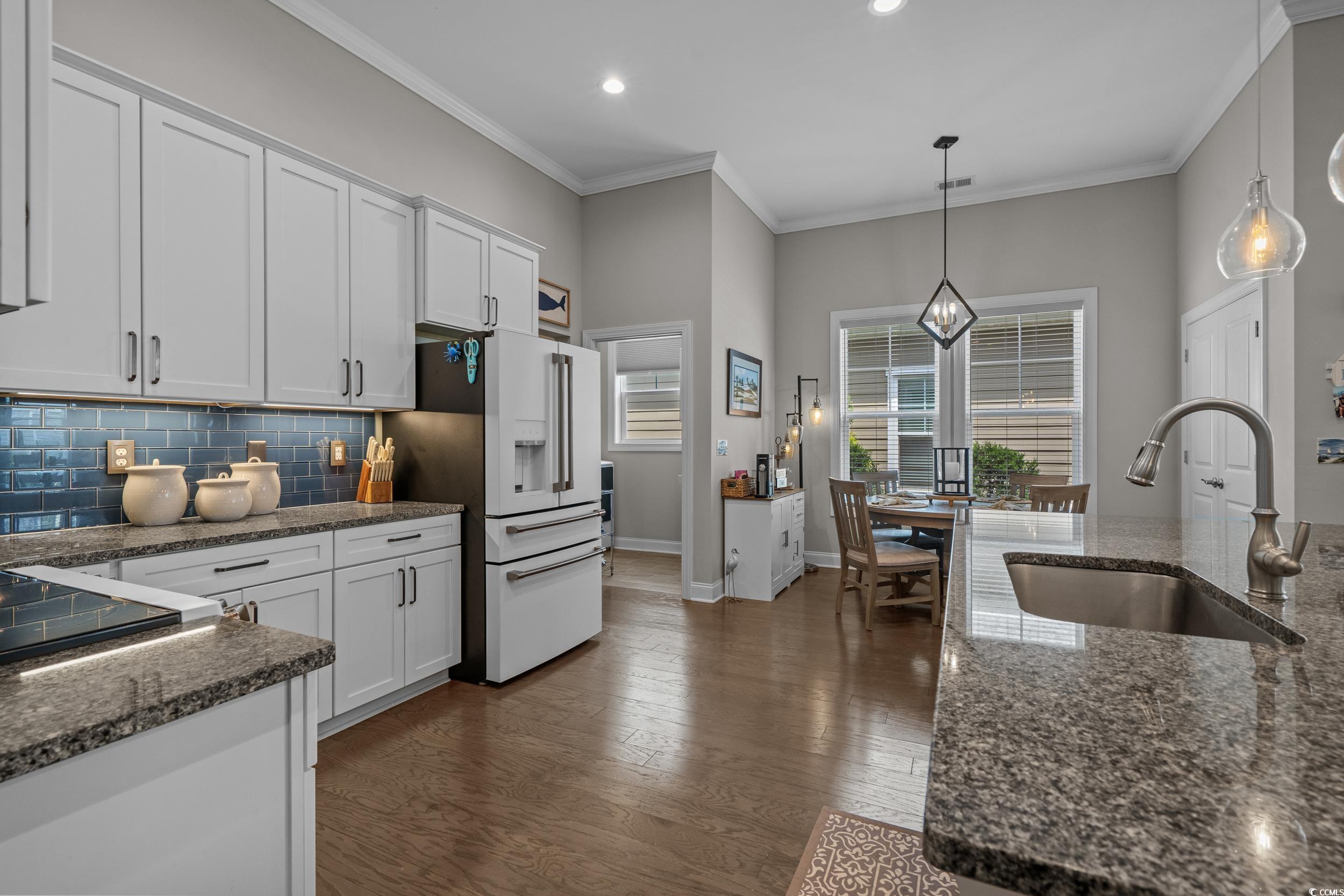 1380 Culbertson Avenue Myrtle Beach, SC 29577 - Photo 16 of 50 Kitchen with a sink, white fridge with ice dispenser, healthy amount of natural light, white cabinets, and recessed lighting