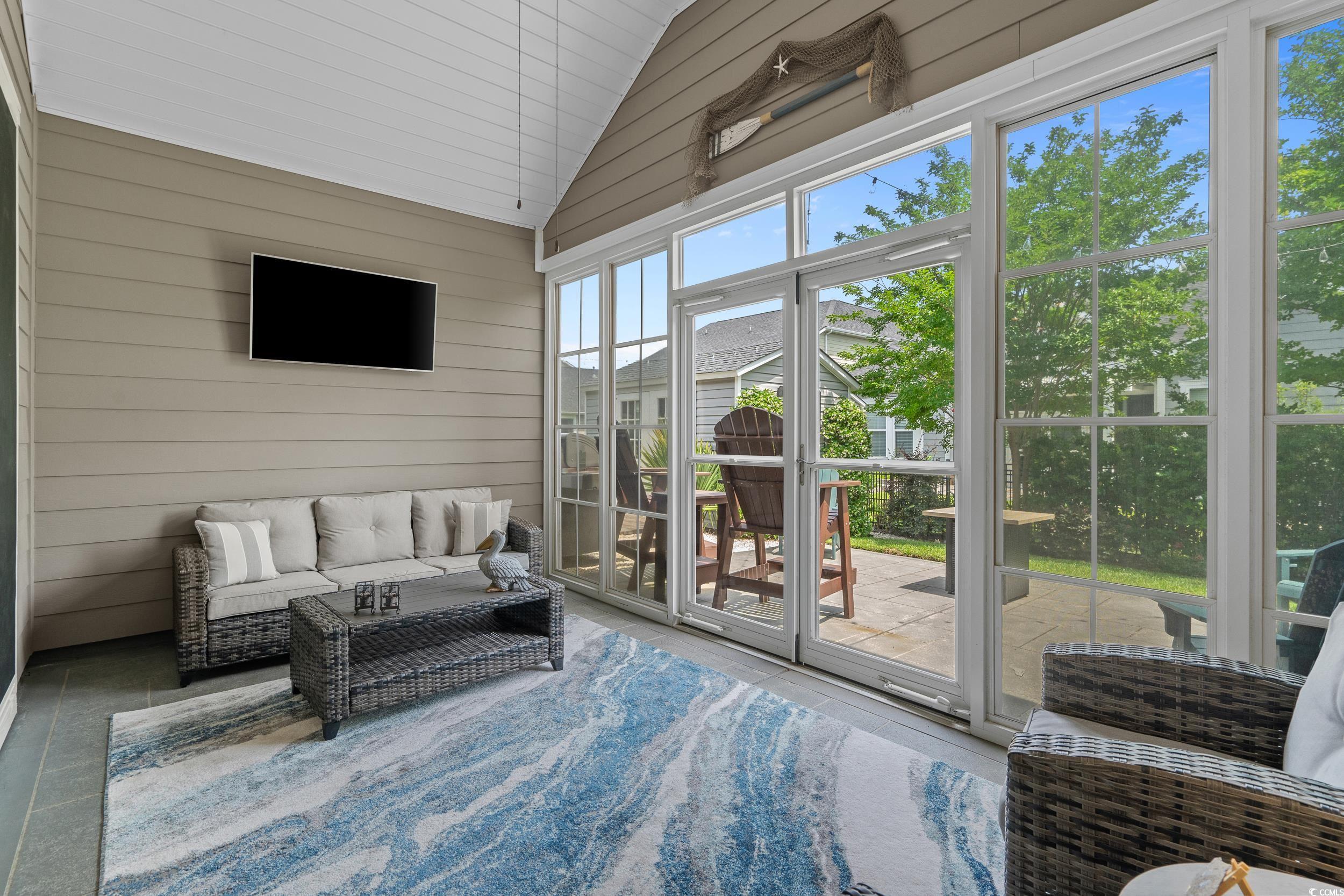1380 Culbertson Avenue Myrtle Beach, SC 29577 - Photo 24 of 50 Sunroom with vaulted ceiling and outdoor lounge area