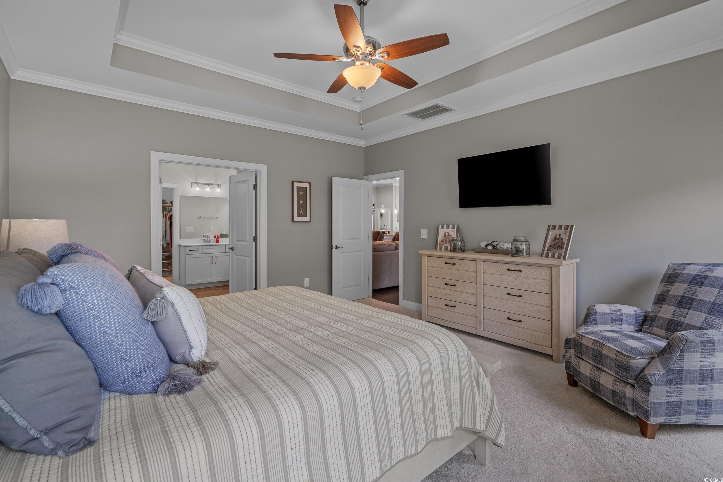 1380 Culbertson Avenue Myrtle Beach, SC 29577 - Photo 33 of 50 Bedroom with a tray ceiling, light carpet, crown molding, connected bathroom, and ceiling fan