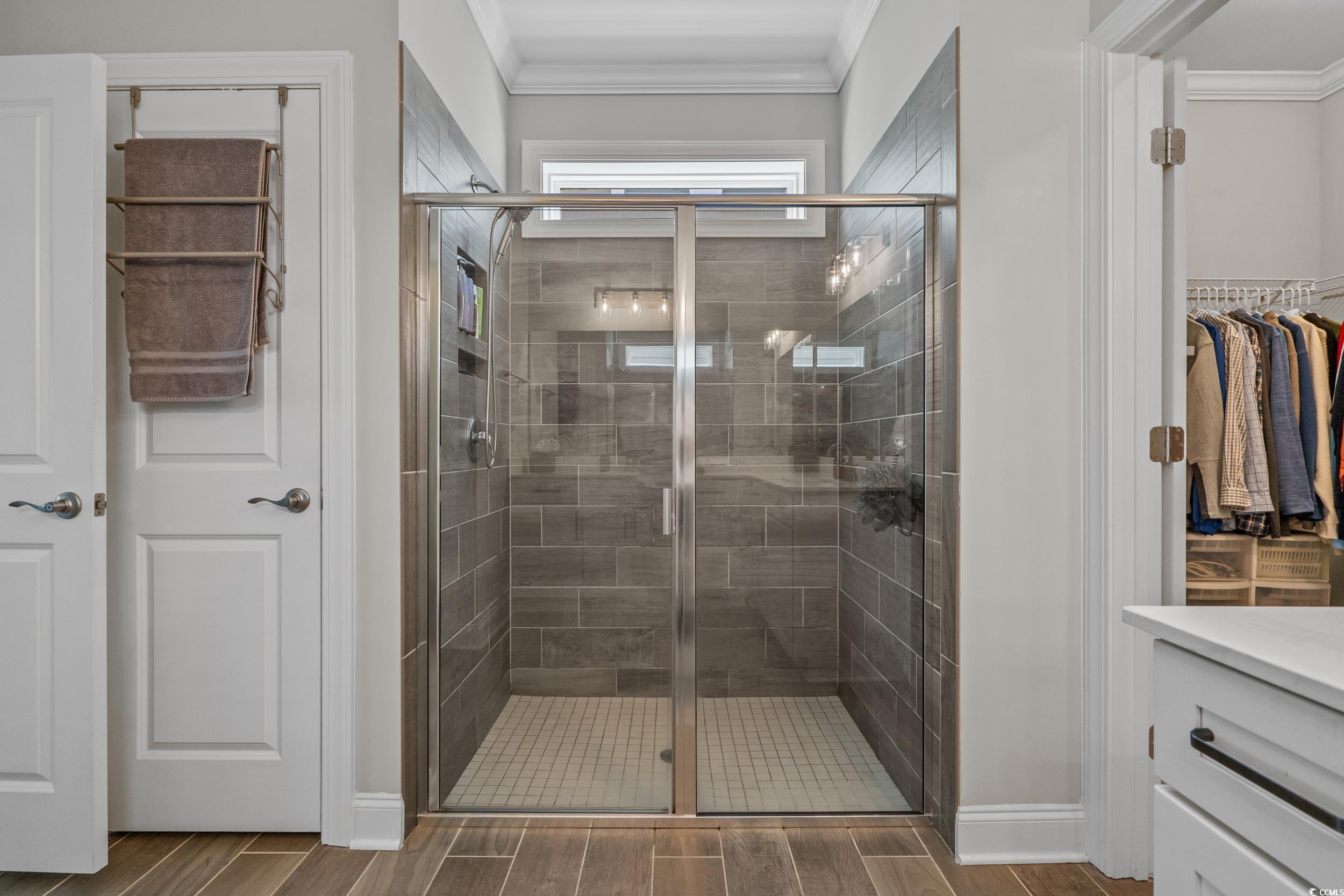 1380 Culbertson Avenue Myrtle Beach, SC 29577 - Photo 36 of 50 Bathroom featuring ornamental molding, a stall shower, vanity, wood tiled floors, and baseboards