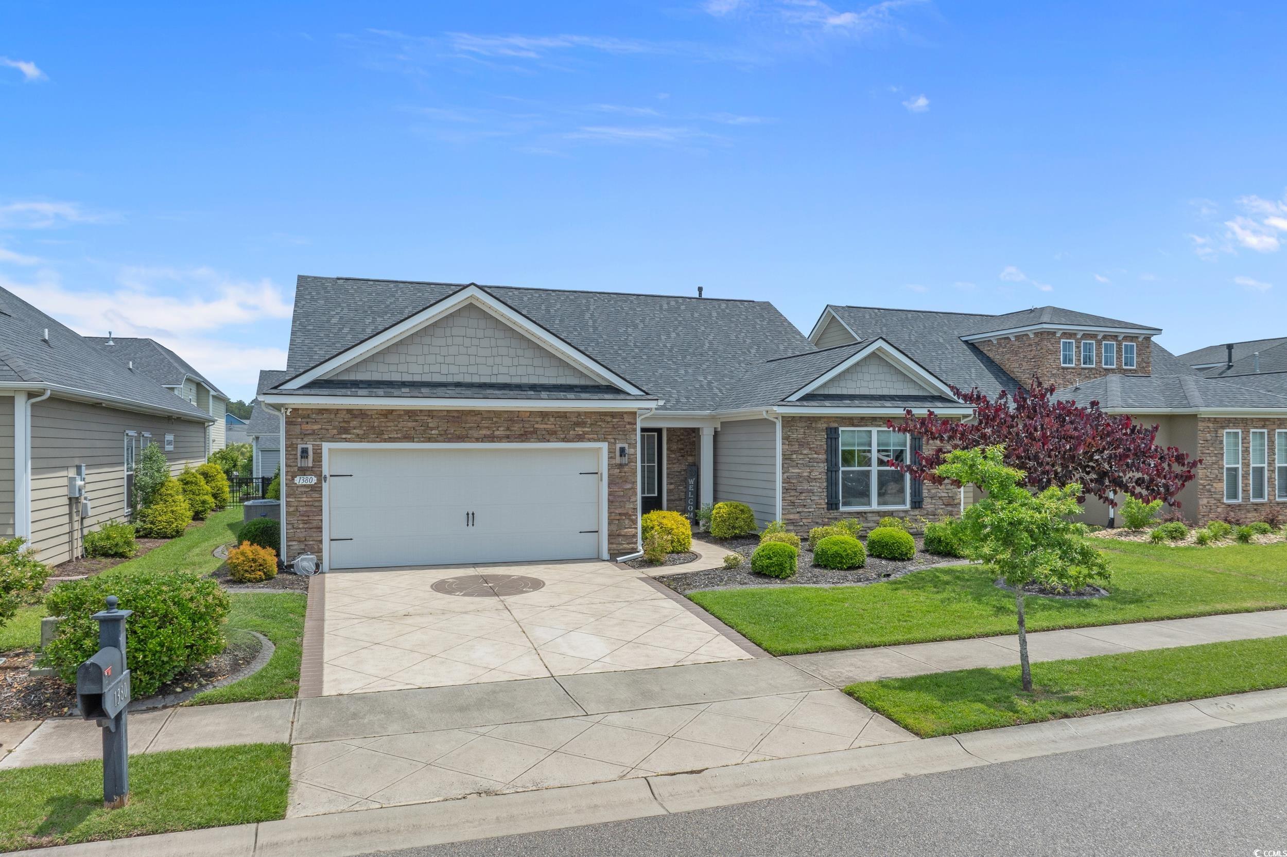 1380 Culbertson Avenue Myrtle Beach, SC 29577 - Photo 4 of 50 Craftsman inspired home featuring driveway, a front yard, an attached garage, a shingled roof, and stone siding