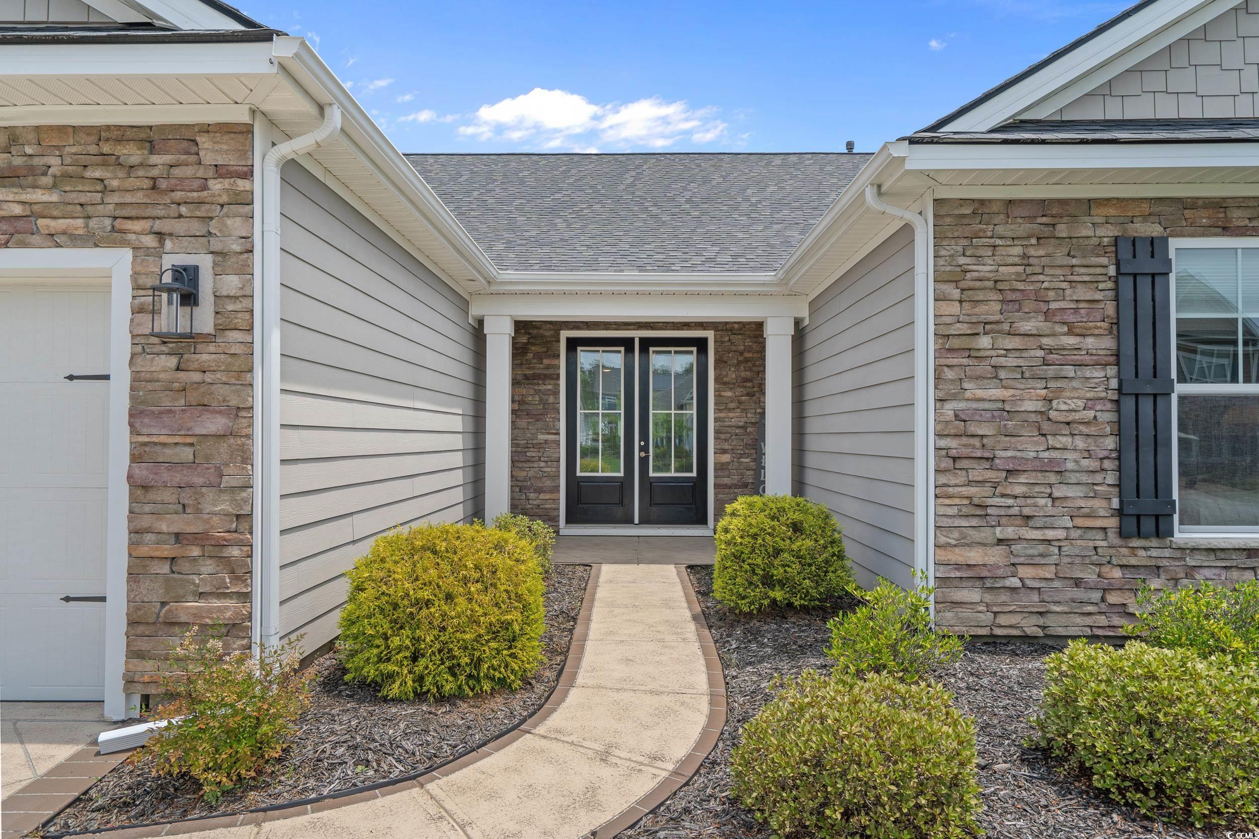 1380 Culbertson Avenue Myrtle Beach, SC 29577 - Photo 5 of 50 Property entrance with stone siding, a shingled roof, and french doors