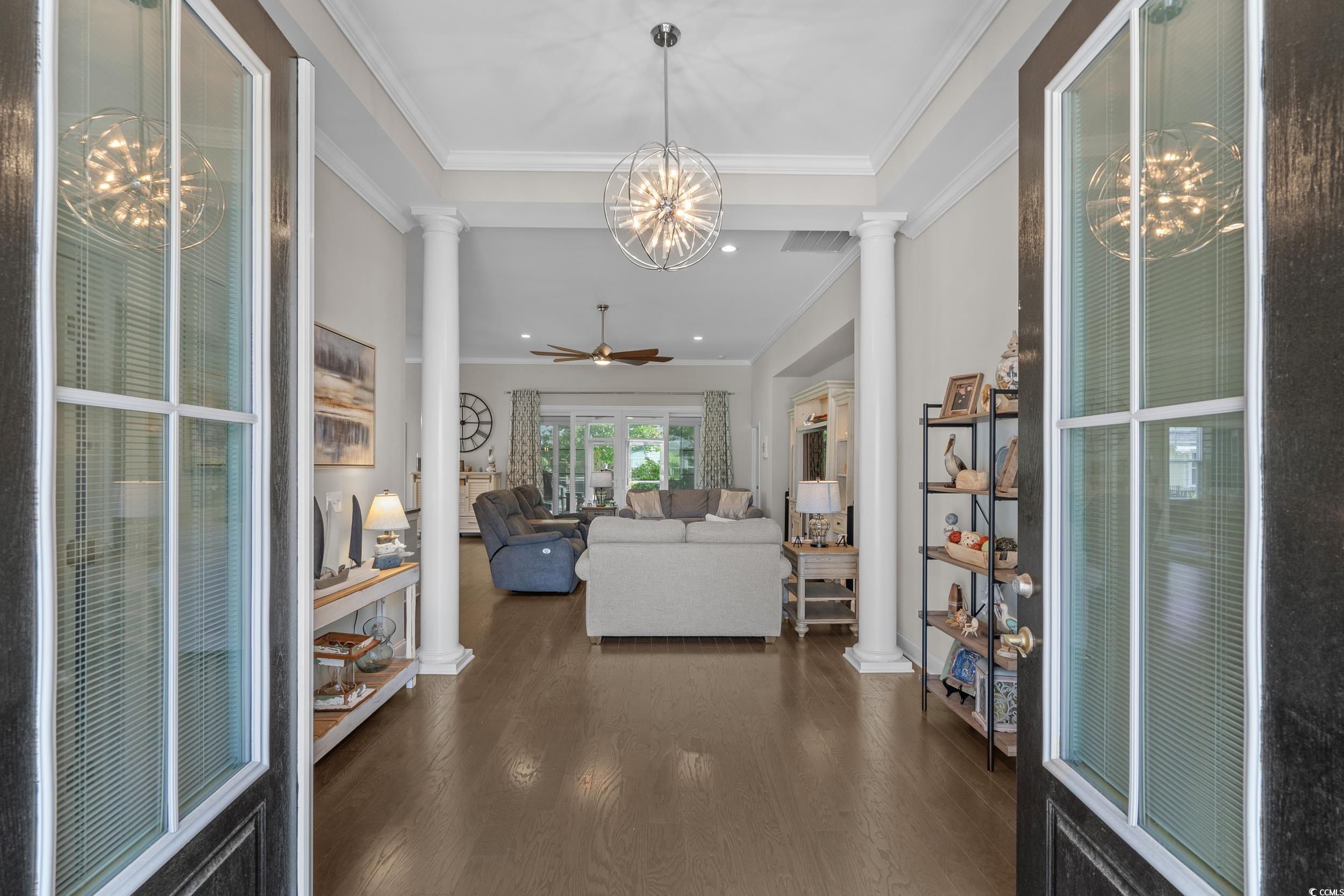 1380 Culbertson Avenue Myrtle Beach, SC 29577 - Photo 6 of 50 Foyer with decorative columns, dark wood-type flooring, ornamental molding, a chandelier, and ceiling fan