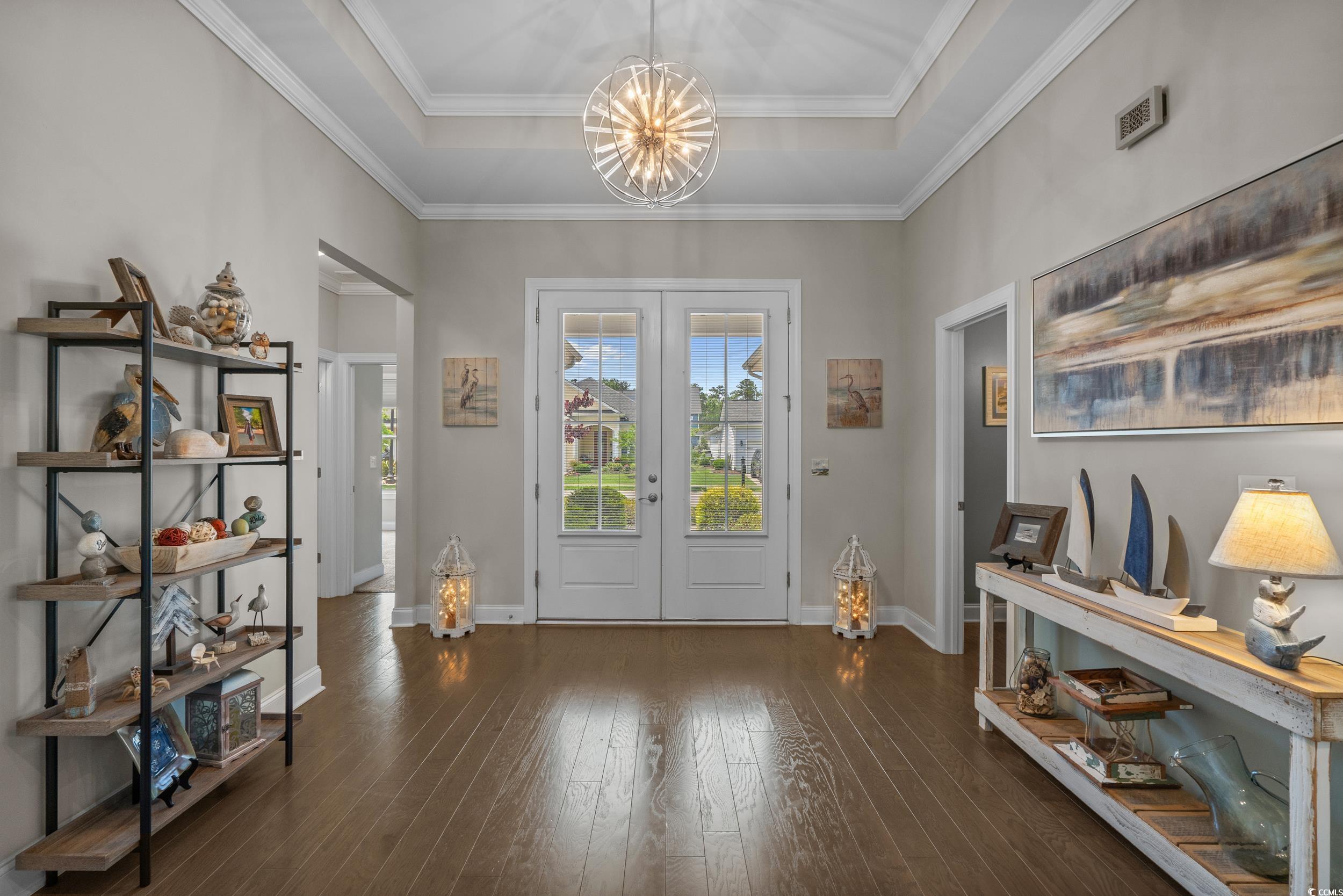 1380 Culbertson Avenue Myrtle Beach, SC 29577 - Photo 7 of 50 Entryway featuring a chandelier, hardwood / wood-style flooring, baseboards, a raised ceiling, and ornamental molding
