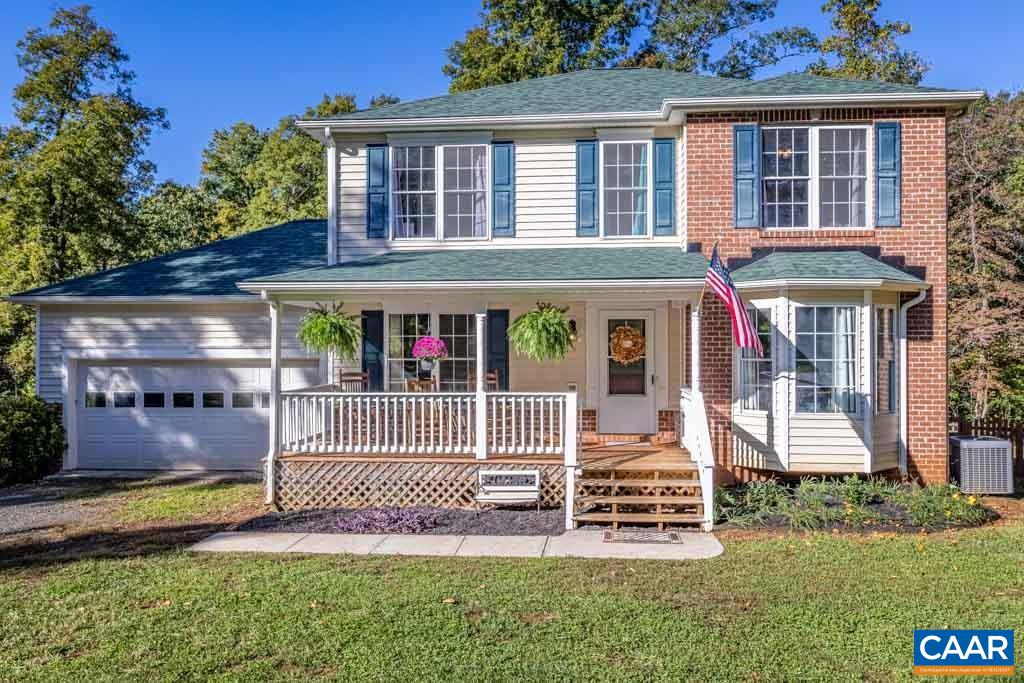 a view of a house with a yard and furniture