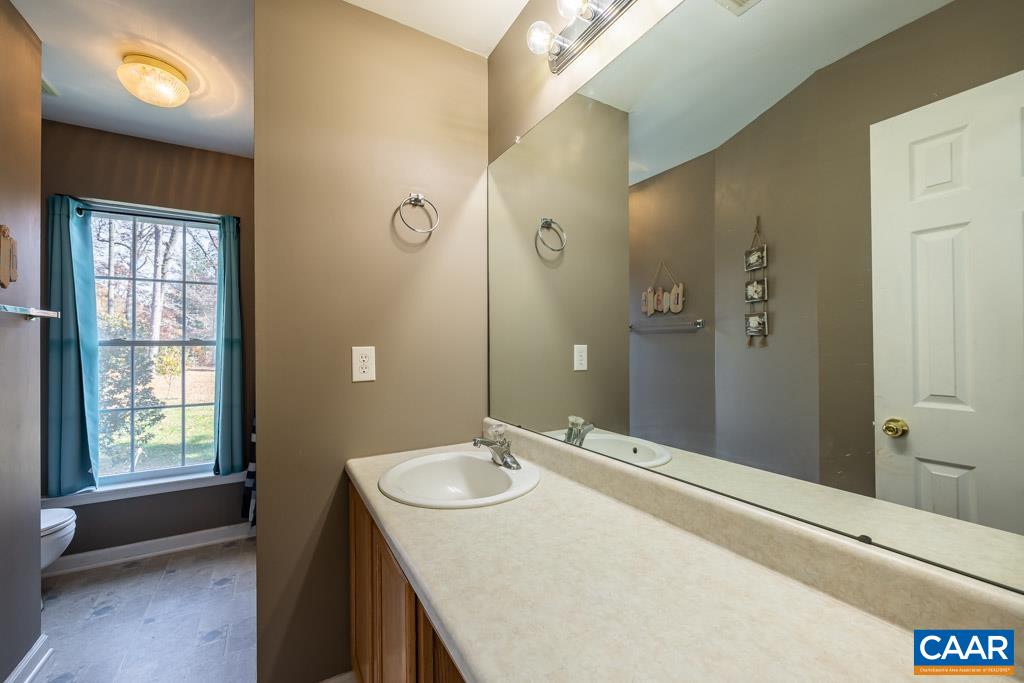 1605 Beautiful Run Road Aroda, VA 22709 - Photo 28 of 63 a bathroom with a granite countertop sink a mirror and a shower