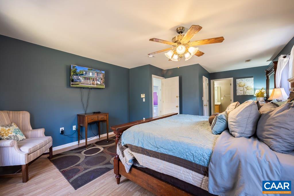 1605 Beautiful Run Road Aroda, VA 22709 - Photo 32 of 63 a bedroom with a bed and a chandelier