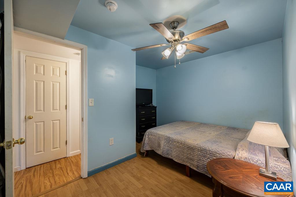 1605 Beautiful Run Road Aroda, VA 22709 - Photo 40 of 63 a bedroom with a bed and a chandelier