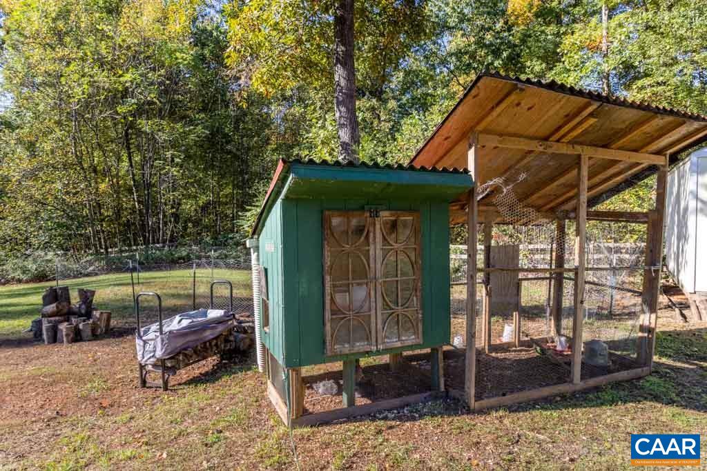 1605 Beautiful Run Road Aroda, VA 22709 - Photo 51 of 63 a backyard of a house with barbeque oven table and chairs