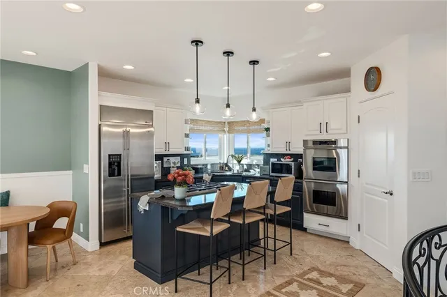 a kitchen with a stove a microwave and a window