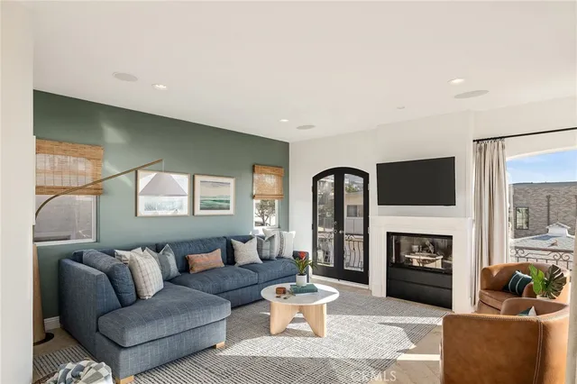 a very nice looking room with a large window and furniture