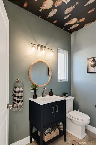 a view of a hallway with wooden floor and a potted plant