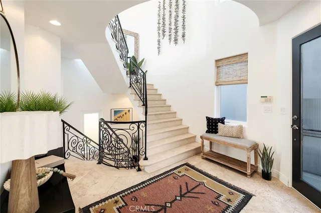 a kitchen with stainless steel appliances kitchen island granite countertop a sink and a refrigerator