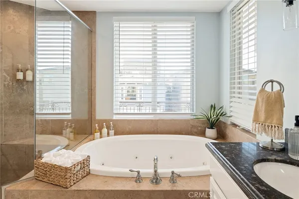 a bathroom with a granite countertop sink toilet and mirror
