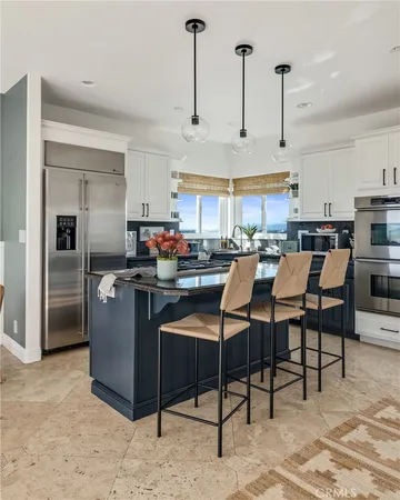 a kitchen with stainless steel appliances granite countertop a stove and a refrigerator