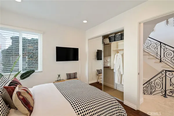 a bedroom with a bed and a flat screen tv