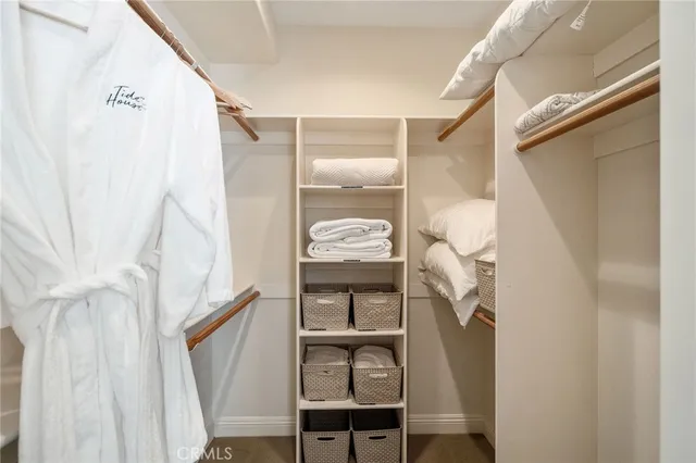 a bedroom with two beds and painting on the wall