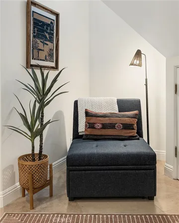 a bedroom with two beds and painting on the wall