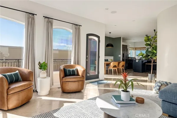 a living room with furniture a fireplace and a floor to ceiling window
