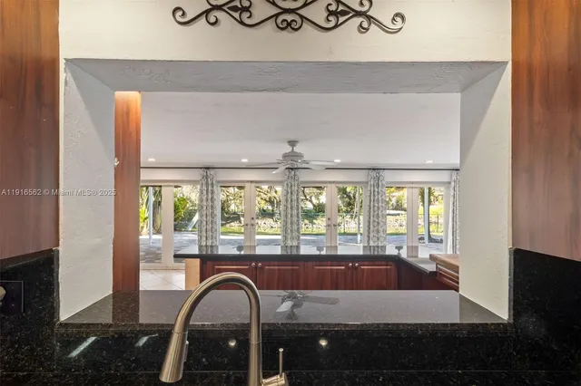 a living room with a floor to ceiling window and a rug