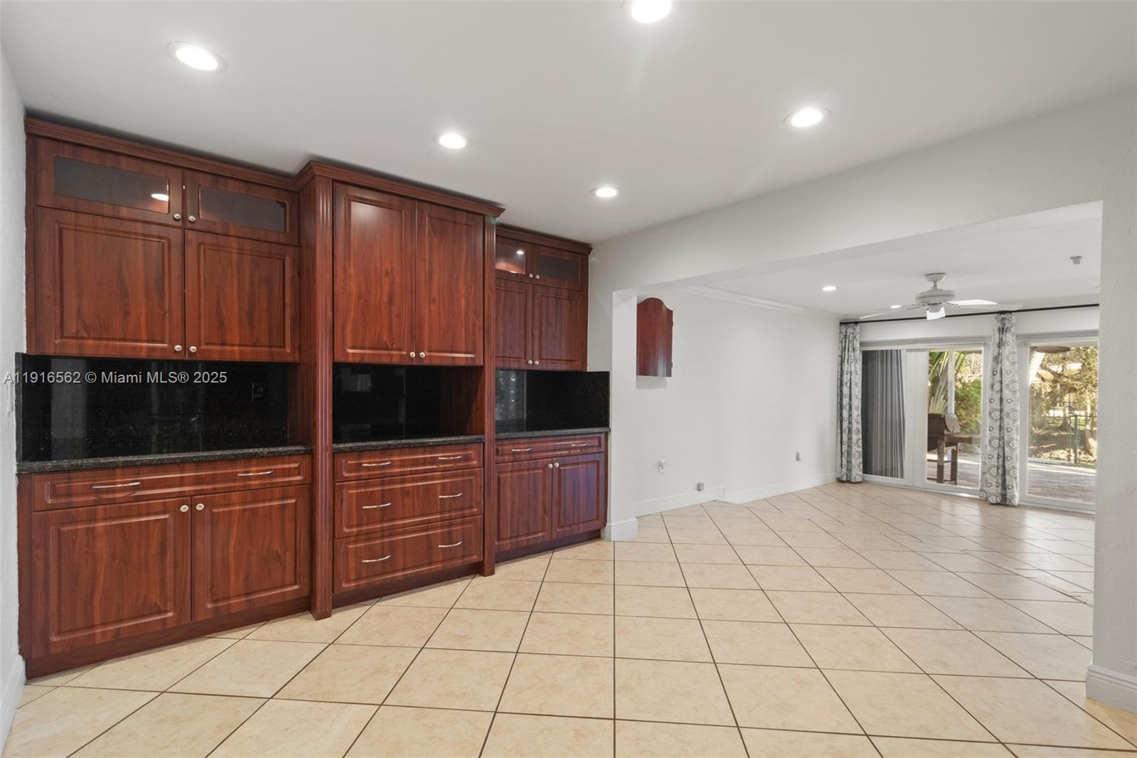 10485 Southwest 109th Street Miami, FL 33176 - Photo 15 of 45 a large kitchen with granite countertop a stove a sink and a microwave