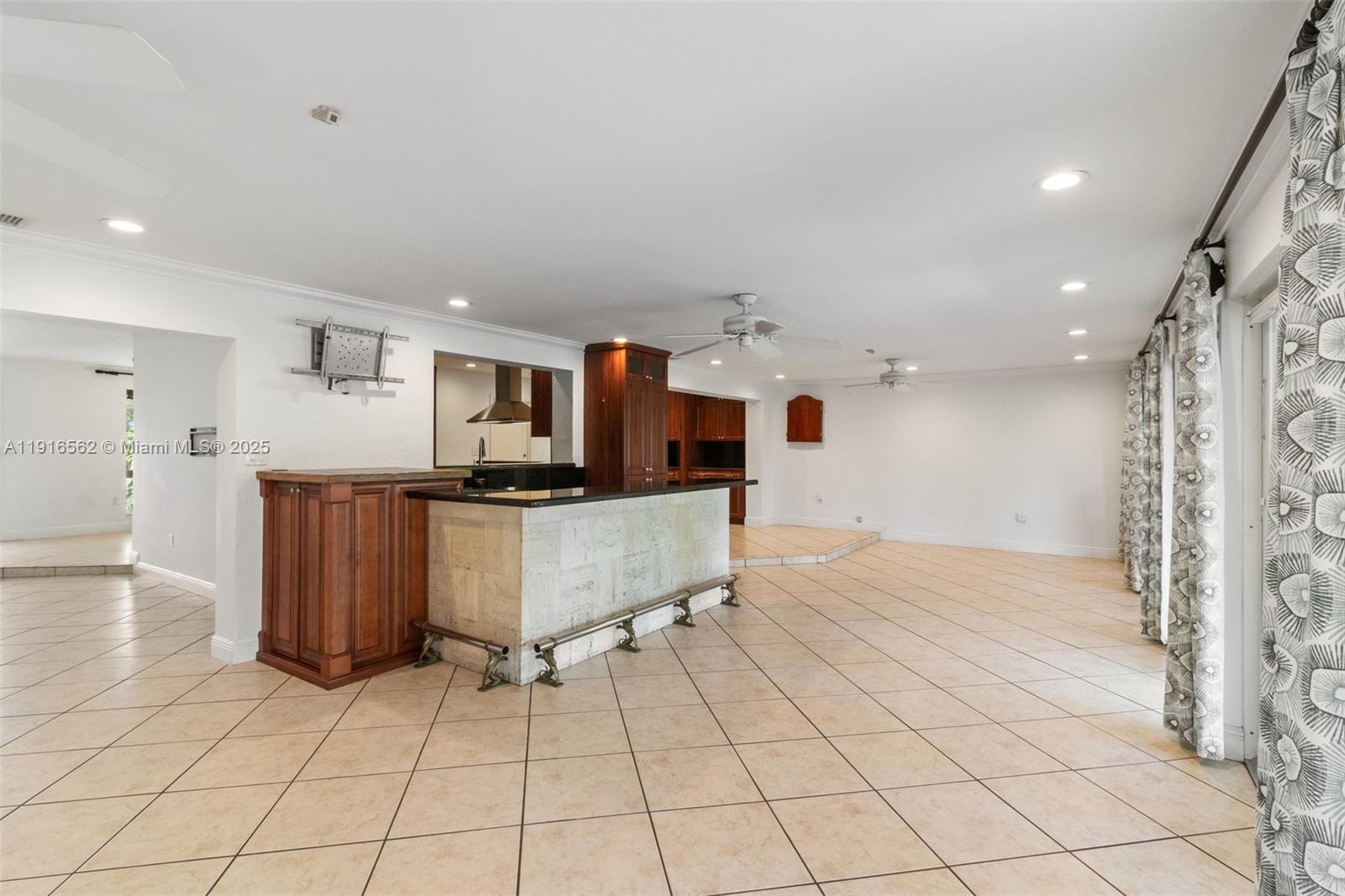 10485 Southwest 109th Street Miami, FL 33176 - Photo 19 of 45 a kitchen with stainless steel appliances kitchen island granite countertop a refrigerator and a stove top oven