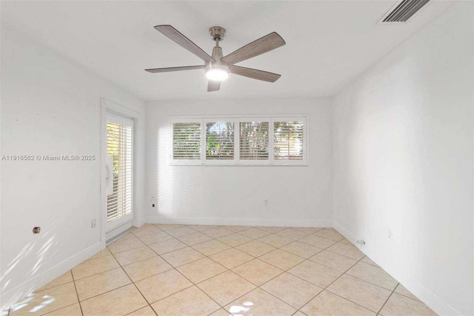 10485 Southwest 109th Street Miami, FL 33176 - Photo 22 of 45 an empty room with windows and fan