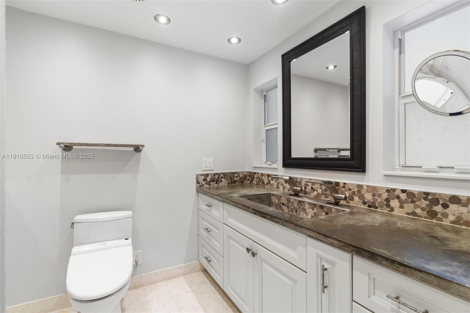 10485 Southwest 109th Street Miami, FL 33176 - Photo 26 of 45 a bathroom with a toilet sink and mirror