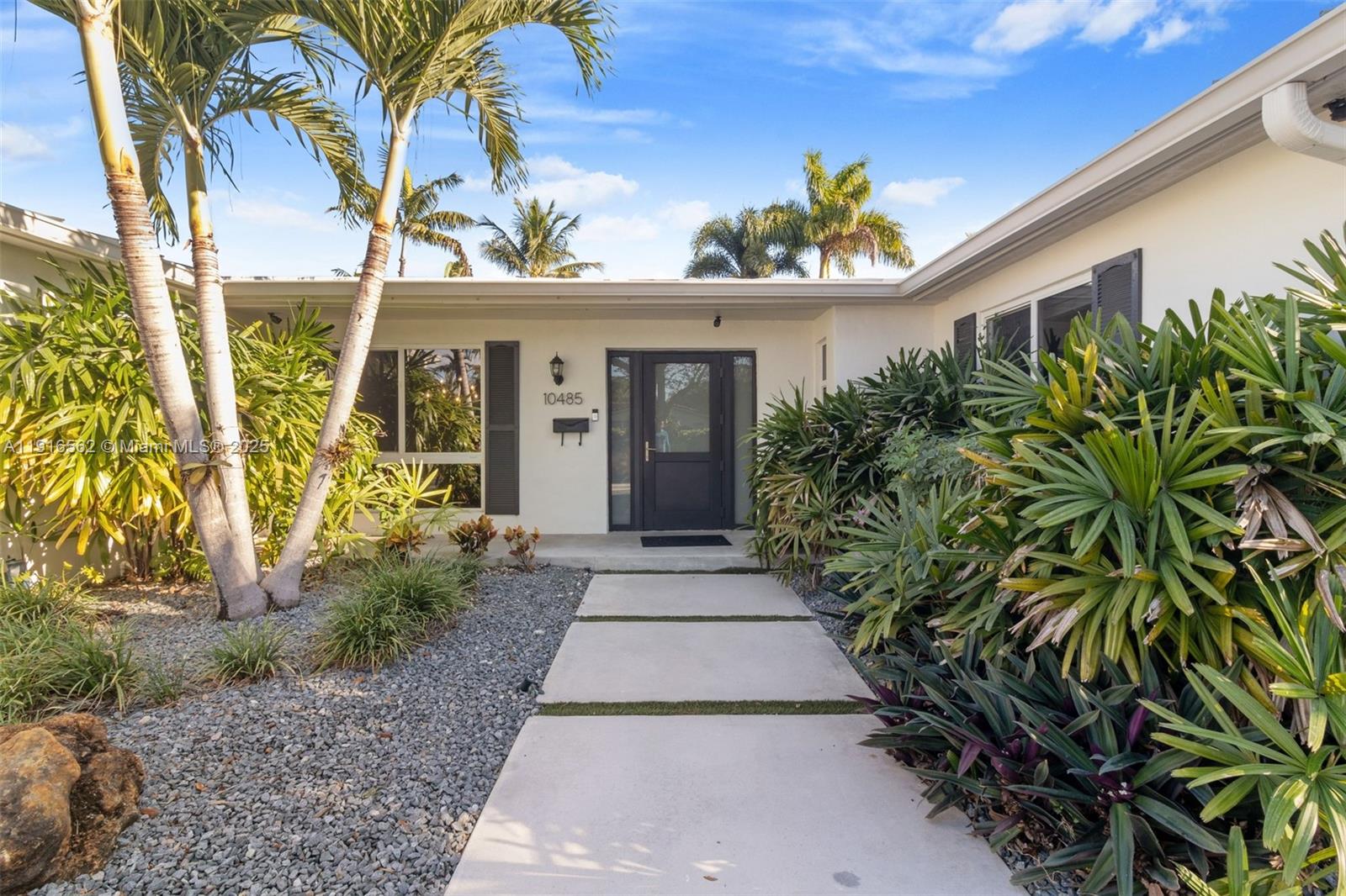 10485 Southwest 109th Street Miami, FL 33176 - Photo 3 of 45 a front view of a house with a yard and potted plants